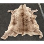 A real fur skin rug 135x117cm approx.