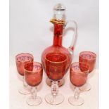 Vintage French rouge glass with gilded accents decanter with one large and four small goblets.