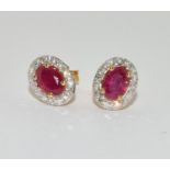 A pair of Ruby/Diamond 18ct gold earrings.