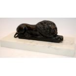 Bronze figure of a recumbent lion mounted on a marble plinth. O/all width 29.5cms