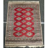 Large Bokhara Pakistan carpet on red ground 4ft x 6ft.