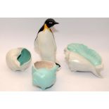 Three Poole Pottery Twin Tone shells c/w a large Poole Pottery penguin.