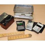 Small collection of vintage calculators, a small sliding scale, wooden folding rules and a pair of