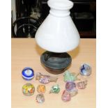 A collection of glass paperweights, many in the form of birds, together with an antique oil lamp