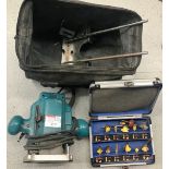 A Makita Router with various attachments and bag.