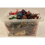 Box of miscellaneous plastic action figures and other toys.