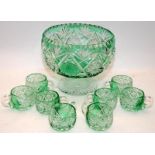 Large footed emerald green cut to clear punch bowl with 8 matching glasses. Has an etched
