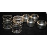 A collection of sterling silver napkin rings. 8 in lot