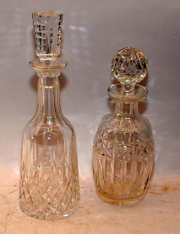 Two crystal glass decanters, the larger 34cms decanter being Waterford Crystal in the Lismore