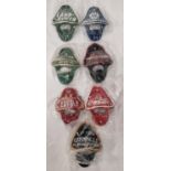 7 Coloured bottle openers. (129)