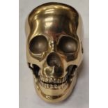 A gold colored skull. (127)