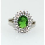 A large 925 silver cluster ring with green stone to centre Size M
