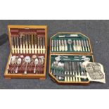 Two vintage wooden cutlery canteens containing complete sets of silver plated flatware.