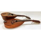 A pair of antique mandolins with decorative mother of pearl inlay.