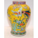 Oriental Famille rose on yellow ground vase 24cms tall. signature and drilled hole to base