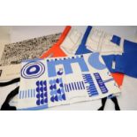 A collection of Modern Art inspired household items including tea towels and an apron.