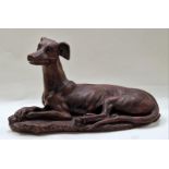 A bronzed resin large figurine of a lying greyhound 52x29x21cm.