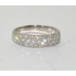 A platinum and diamond set band ring Size M, 4.5g