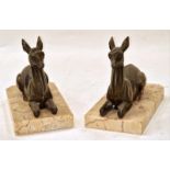 A pair of vintage brass recumbent deer book ends on marble bases each measuring 13x16x9cm.