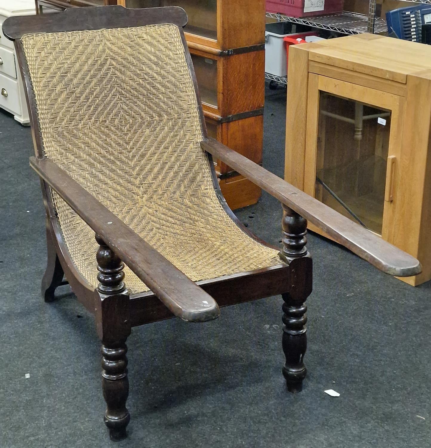 Anglo Dutch colonial Plantation chair with arm extenders on turned supports with a woven back rest