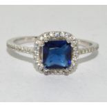 A 925 silver halo style blue stone ring Size O