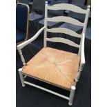 Large rustic painted open arm chair with cane seat 100x78x63cm.