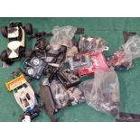 Large collection of Remote Controlled car spare parts to include shells, engines, controllers etc.