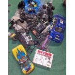 Large collection of Remote Controlled car spare parts to include shells, engines, controllers etc.