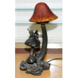 Lamp base in the form of a fairy on a toadstool with a toadstool shaped glass shade. 40cms