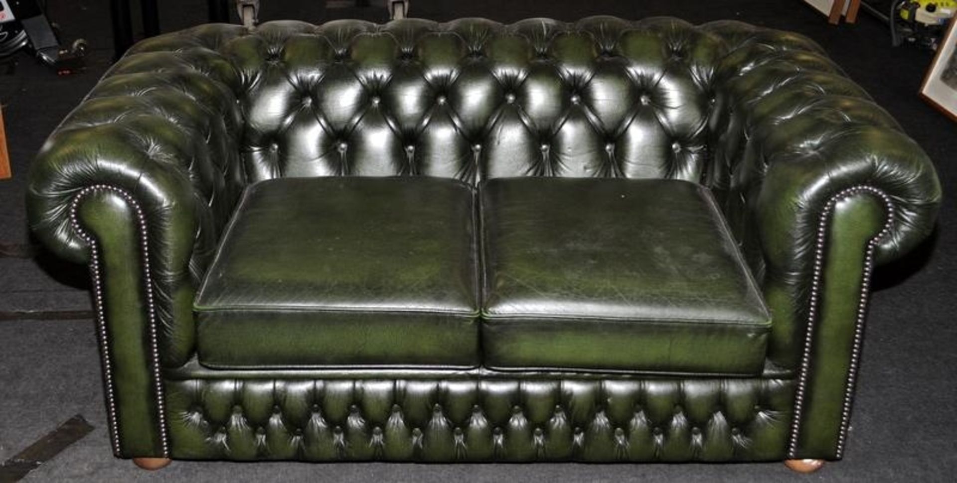 Quality green leather two seater Chesterfield sofa. 160cms across back, 40cms seat height.