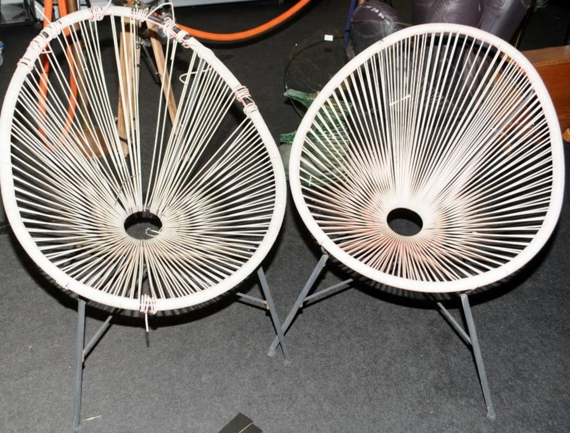 A pair of wire work armchairs.