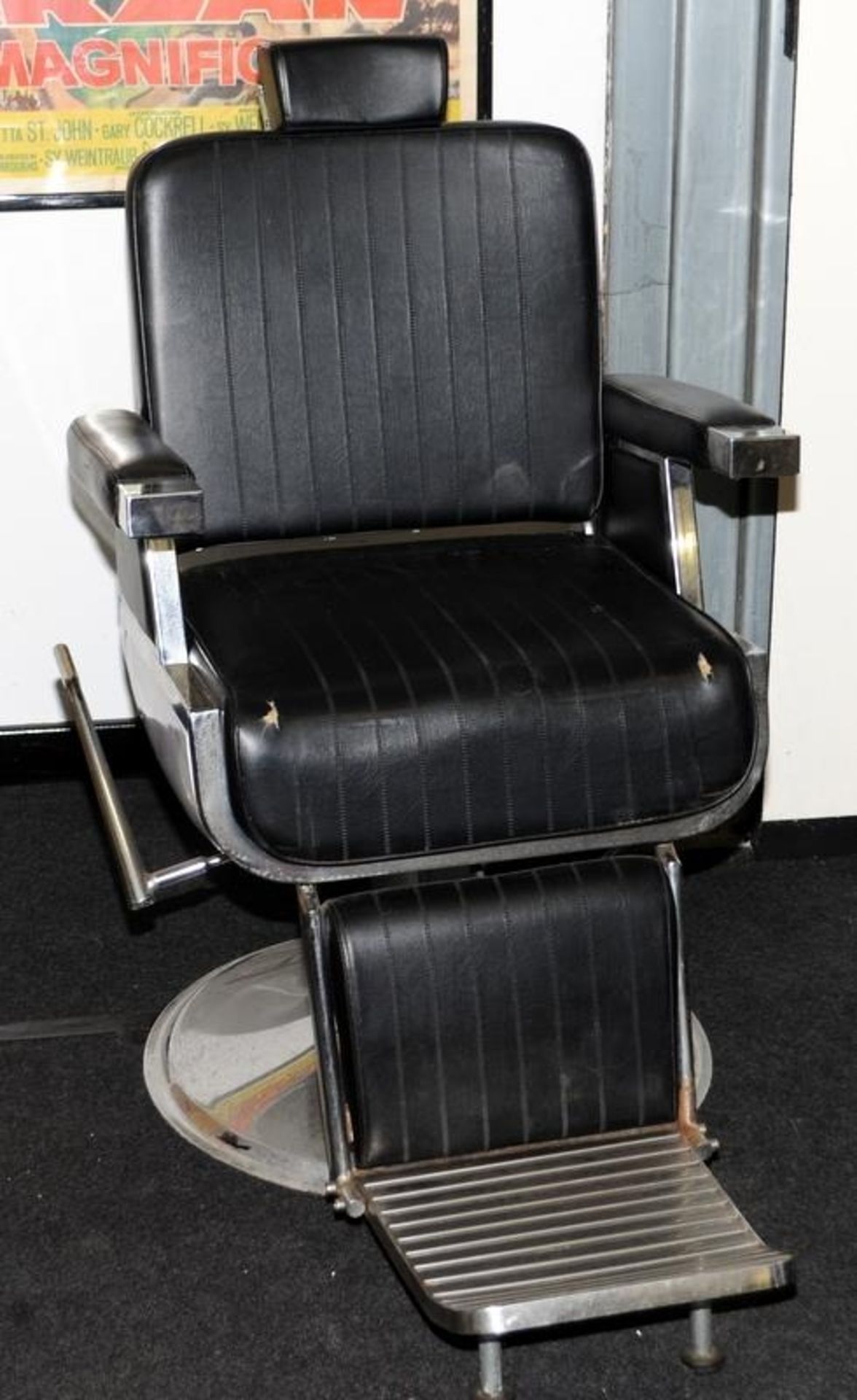 Genuine vintage dentists chair in black vinyl with chrome base.