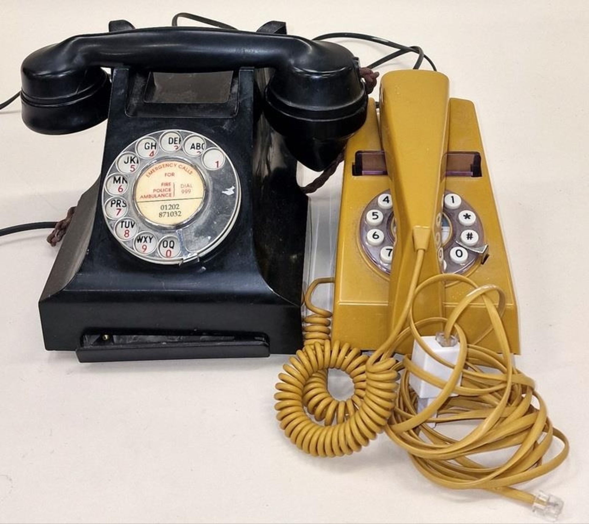 2 vintage phones on a GPO Bakelite the other a PO trim phone