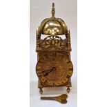 Vintage brass lantern clock with key.