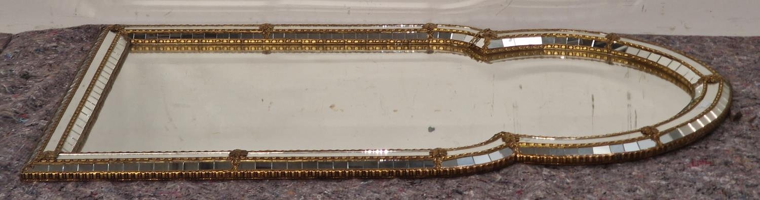 Moorish style gilt frame mirror set with cushioned mirror tiled edging in a contemporary shape