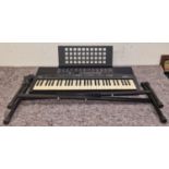 Yamaha PSR-210 electric keyboard on stand with cables