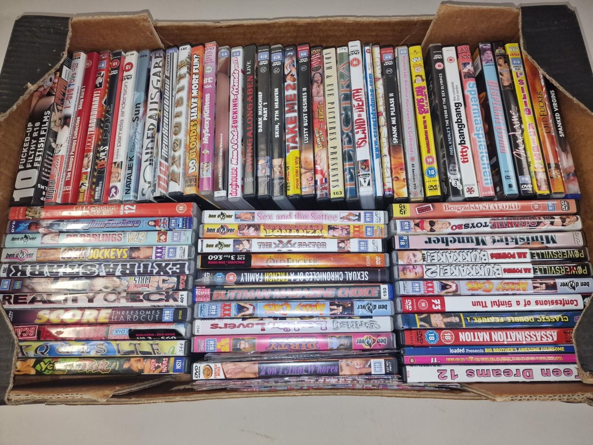 Large tray of various naughty X rated pornographic DVD’s.