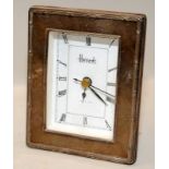 Small silver Harrods quartz mantel clock. 12cms tall
