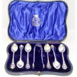 Set of six cased sterling silver teaspoons c/w sugar tongs with pierced decoration to finials.