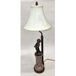 Vintage table lamp designed as a brass cherub on top of a marble column. Includes shade 64cm tall.