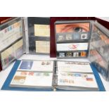 Three stamp albums containing first day covers, presentation packs and related items