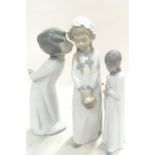 Three Nao figures of children.