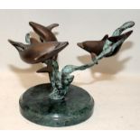 Bronze featuring three swimming dolphins, unsigned. 13cms tall