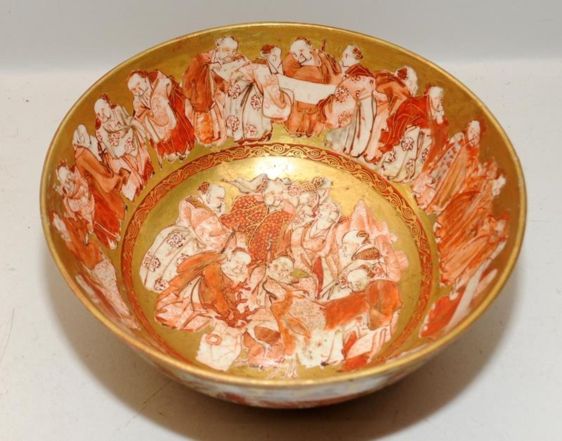 Japanese Kutani red and gold bowl featuring the Immortals. With repairs. 21cms across - Image 2 of 4