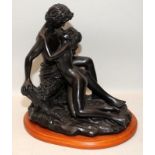 Bronzed resin figure of two lovers. 27cms tall