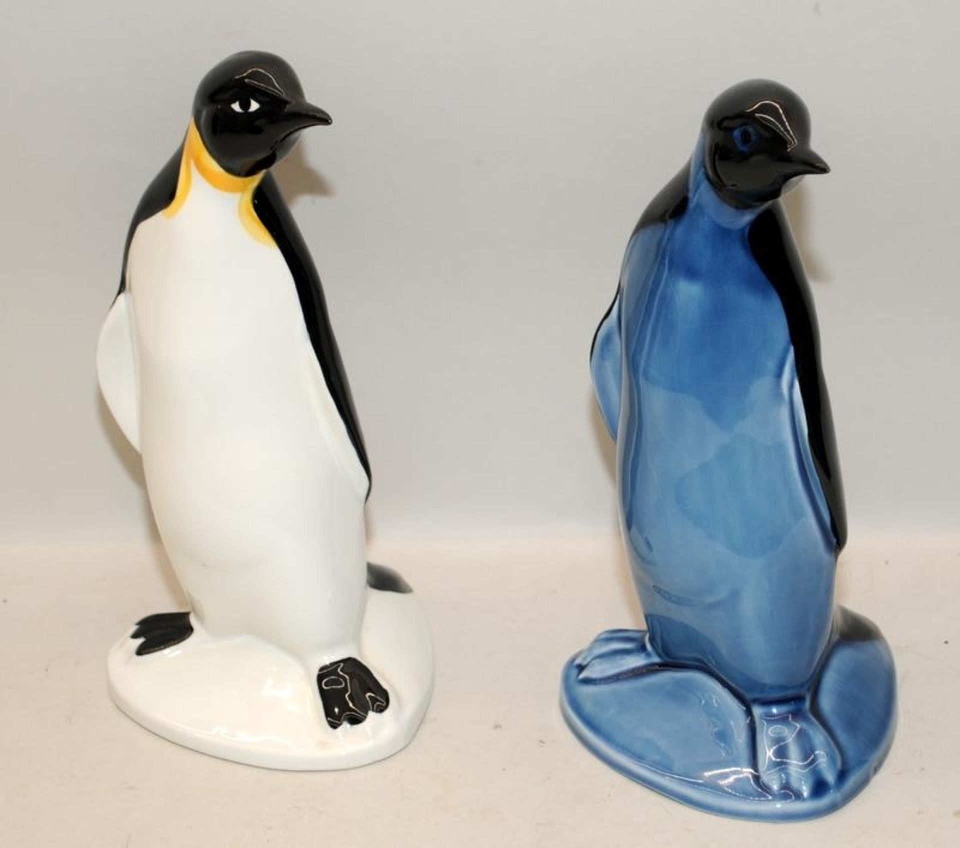 Pair of Poole Pottery large Penguins, one white and one blue. 23cms tall