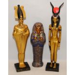 Ceramic Egyptian male and female Pharaoh figures c/w a sarcophagus. Largest figure is 43cms tall