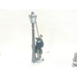 A Lladro lamp lighter figure.