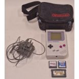 Nintendo Game Boy console together with a Nintendo power supply, Nintendo braned carry case and