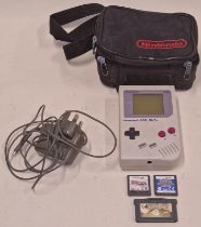 Nintendo Game Boy console together with a Nintendo power supply, Nintendo braned carry case and